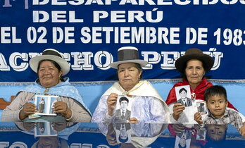 De izquierda a derecha, Lidia Flores Huamá́n, presidenta de Anfasep; Adelina García, vicepresidenta de Anfasep; y Eudocia Conde sostienen las fotografías de sus esposos desaparecidos.